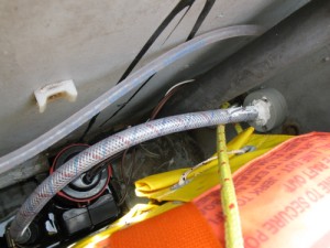 Image: The intake hose is the larger diameter one in the footwell. It now goes intact through the cabinet wall on the right. Fresh water comes out of the clear hose.